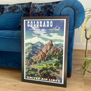 May include: Vintage travel poster advertising a trip to Colorado with a United Airlines aeroplane flying over a mountain range. The poster features a blue sky with white clouds and a green valley with red rock formations. The text on the poster reads "Colorado" and "United Air Lines".