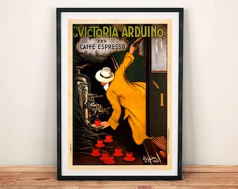 May include: Framed vintage poster advertising "La Victoria Arduino" espresso. The artwork depicts a man in a yellow coat and hat reaching for a cup of coffee. Red cups are arranged on a table, and a coffee machine is visible.