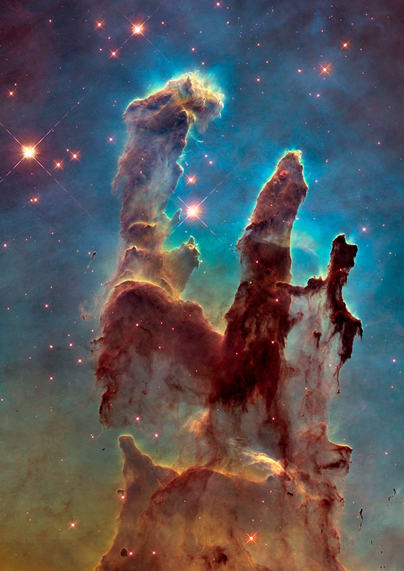 May include: A vibrant nebula with tall, red, and orange pillars of gas and dust, illuminated by bright blue and white stars. The background is a dark blue with scattered stars.
