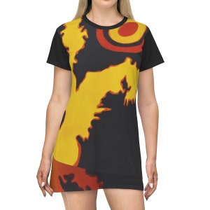 May include: A black t-shirt dress with a yellow, orange, and red abstract design. The design features a large yellow shape with a red circle in the upper right corner.