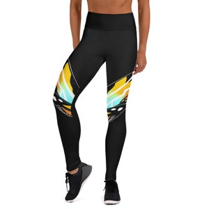 May include: Black yoga leggings with a colorful butterfly design on the sides. The leggings have a high waist and are made of a stretchy, comfortable fabric.