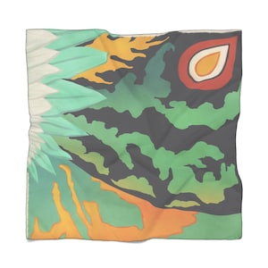 May include: A green, orange, and black patterned scarf with a large eye design. The eye is red, orange, and white.