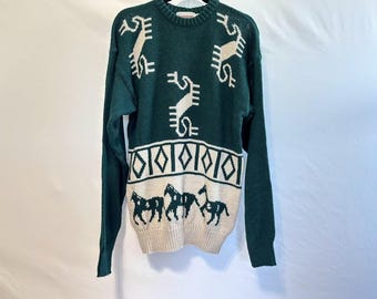 May include: A green sweater with white geometric patterns and horse silhouettes. The sweater features a crew neck and long sleeves. The design includes a band of diamonds and stylized figures.