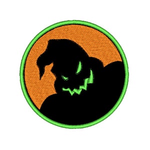 May include: Embroidered patch with a black silhouette of a character with a sinister grin and a pointed hat, set against an orange background. The design is framed by a green circular border, ideal for Halloween or spooky-themed projects.