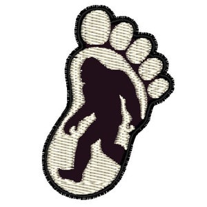 May include: A black silhouette of a Bigfoot walking inside a white outline of a footprint.