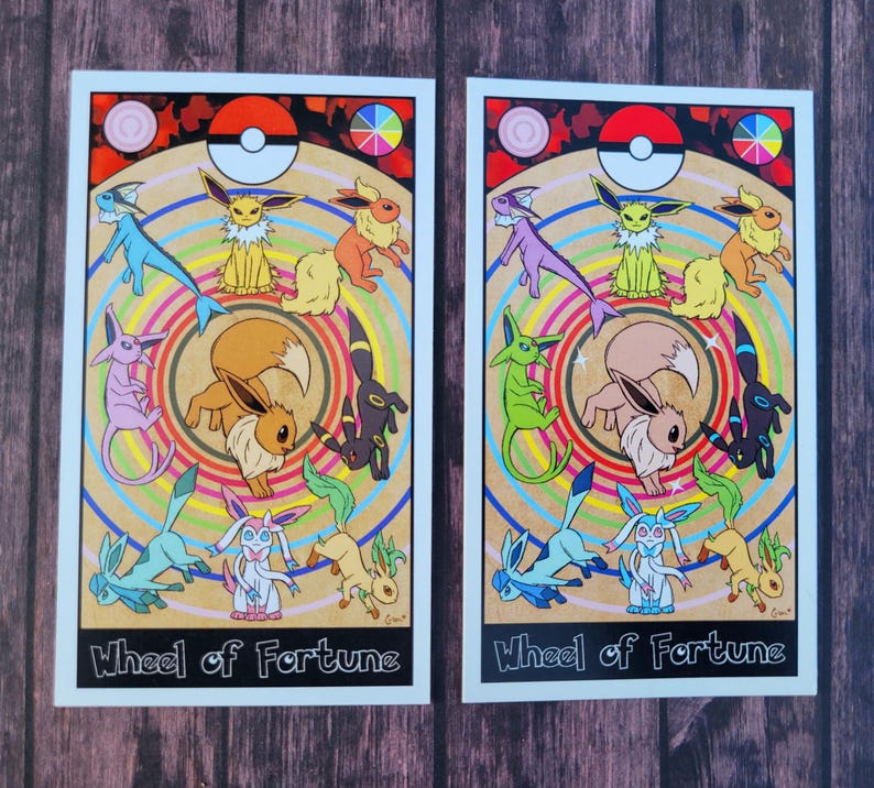 May include: A colorful illustration of the Wheel of Fortune tarot card featuring a circle of nine Eevee evolutions. The card is set against a background of a wooden table. The card features the text "Wheel of Fortune".