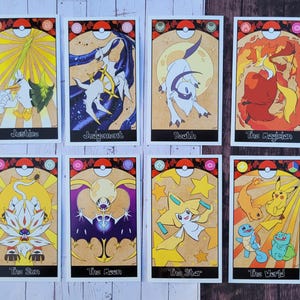 May include: A set of 12 tarot cards featuring Pokemon characters. The cards are illustrated with various Pokemon, including Pikachu, Charizard, and Mewtwo. Each card has a unique design and a title, such as "The Magician", "The Empress", and "The Tower".