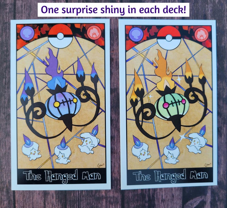 May include: Two tarot cards featuring the "The Hanged Man" card with a Pokemon illustration. The card on the left features a purple and blue Chandelure, while the card on the right features a green and yellow Chandelure.