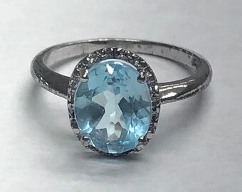925 silver ring with single cut of diamond and oval blue topaz