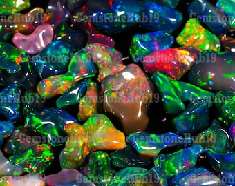May include: A close-up of a collection of colorful, iridescent opal gemstones. The opals are various shapes and sizes, and they are all polished and shiny. The opals are arranged in a random pattern, and they are all on a black background.