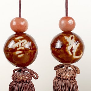 Pair of Chinese porcelain character tasseled scroll weights