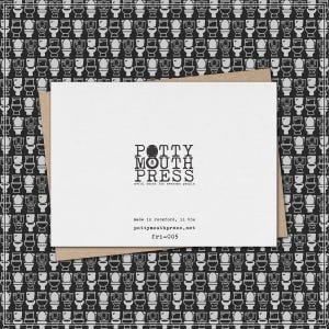 May include: A white greeting card with the text "POTTY MOUTH PRESS" and the tagline "awful cards for awesome people." The card is on a brown envelope, with a black and white toilet pattern background.