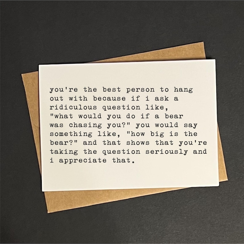 May include: A white card with black text, placed on a brown envelope, against a dark background. The text reads: "you're the best person to hang out with because if I ask a ridiculous question..." A thoughtful gift.