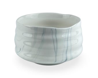 May include: White ceramic teacup with a wavy, textured exterior and a gray marbled design.