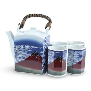 May include: A Japanese tea set with a blue and white teapot with a brown handle and four matching cups. The teapot and cups feature a red mountain and blue sky design.
