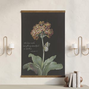 May include: A botanical print on a dark background features a detailed illustration of a flower with yellow and red blooms, a butterfly, and green leaves. The print includes the text "He has made everything beautiful in its time."