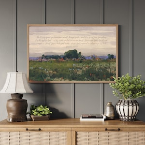 Framed Christian wall art featuring Ephesians 2:8-10 Bible verse over a soft wildflower field landscape, styled in rustic home decor.