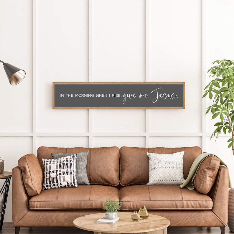 May include: A wooden framed sign with a gray background and white text that reads "In the morning when I rise, give me Jesus."