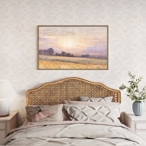A framed print with a watercolor painting of a field with trees and a sunset sky. The print includes the text "Seek First His Kingdom and His Righteousness, and all these things shall be added unto you." Matthew 6:33.
