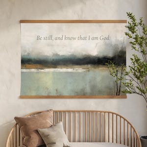Neutral abstract scripture canvas tapestry wall art displaying Be Still and Know in a minimalist, faith-inspired design.