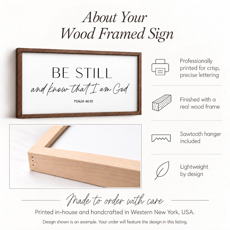 May include: A rectangular wood framed sign with a white background and black text that reads BE STILL and know that I am God PSALM 46:10. The sign features a dark wood frame, a close-up of a light wood frame corner, and icons for printing, wood, and a sawtooth hanger.