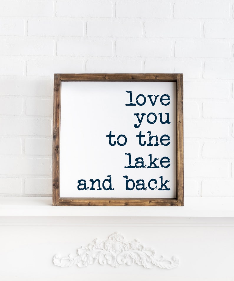 May include: A wooden framed sign with the text "love you to the lake and back" in navy blue lettering.