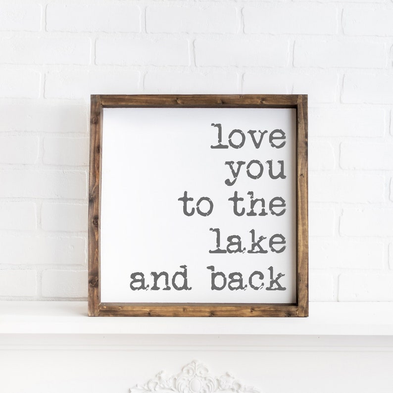 May include: A wooden sign with the text "love you to the lake and back" in a vintage typewriter font.