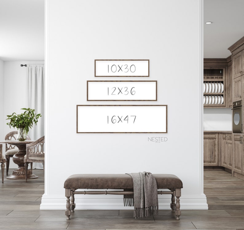May include: Three brown picture frames with white mats are hung on a white wall. The frames are nested, with the smallest frame at the top and the largest frame at the bottom. The frames are labeled with the dimensions 10x30, 12x36, and 16x47. The word "NESTED" is written below the frames.