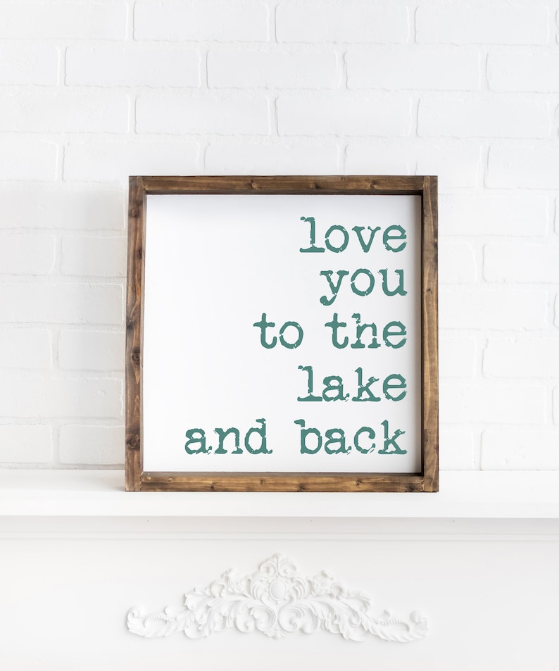May include: A wooden framed sign with the text "love you to the lake and back" in teal green lettering.