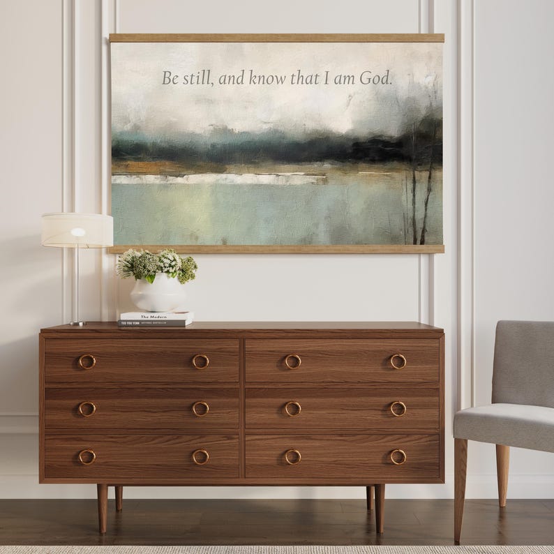 Large muted abstract canvas tapestry with the words Be Still and Know, designed as modern Christian wall art for calm spaces.