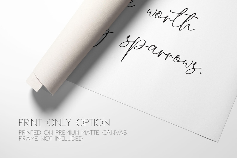 May include: A white matte canvas print featuring black cursive text that reads, "worth sparrows." The canvas is partially rolled at the top left corner. Below the text, the words "PRINT ONLY OPTION" and "PRINTED ON PREMIUM MATTE CANVAS FRAME NOT INCLUDED" are visible.