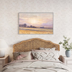 A framed print with a watercolor painting of a field with trees and a sunset sky. The print has a quote from the Bible: "Seek first his kingdom and his righteousness, and all these things will be given to you as well." Matthew 6:33.