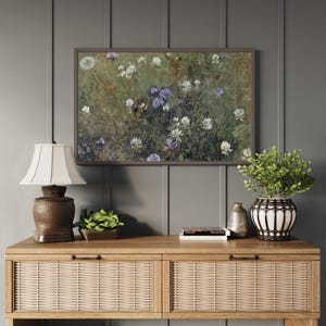 Framed floral meadow artwork in natural wood frame