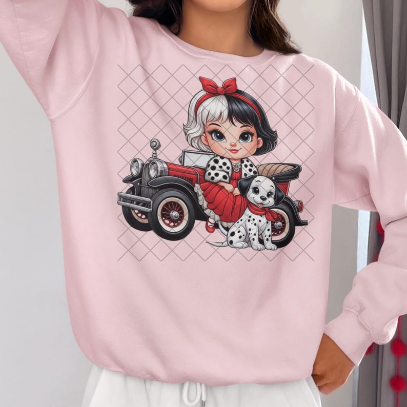 May include: Pink sweatshirt with a cartoon illustration of a girl with black and white hair wearing a red dress and holding a dalmatian puppy. The girl is standing next to a red vintage car.