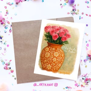 May include: A watercolor illustration of a bouquet of pink roses in a terracotta vase with a floral pattern. The vase is on a light green background with the text "Feliz dia de las Madres" in Spanish. The image is signed with the text "@artkandy".