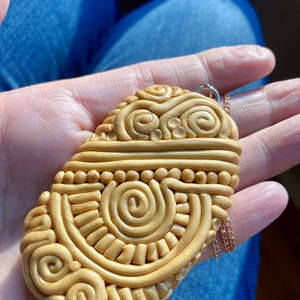 Polymer clay pendant with Aztec psychedelic design