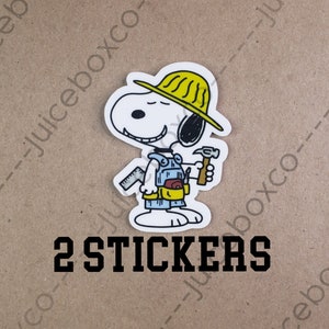 May include: Two white vinyl stickers featuring a cartoon dog wearing a yellow hard hat and overalls holding a hammer and a ruler. The text "2 STICKERS" is printed below the image.