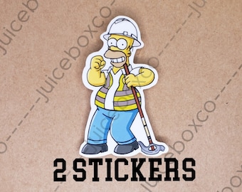 May include: Two yellow and blue cartoon construction worker stickers featuring Homer Simpson from The Simpsons. The stickers feature the text "2 STICKERS".