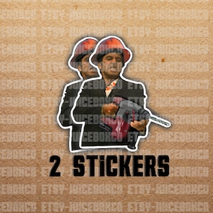 May include: Two stickers featuring a man wearing a hard hat and holding a power drill. The text "2 STICKERS" is printed below the image.