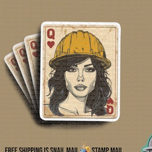 May include: A vintage-style playing card featuring the Queen of Hearts. The Queen is depicted wearing a yellow hard hat and has a serious expression. The card has a worn and faded look, suggesting it has been used many times.