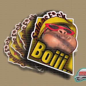 May include: A yellow and black sticker with a cartoon image of a person wearing a yellow hard hat and red sunglasses. The text "Safe as F*ck" and "Boiii!" is printed on the sticker. The sticker is part of a set of stickers.