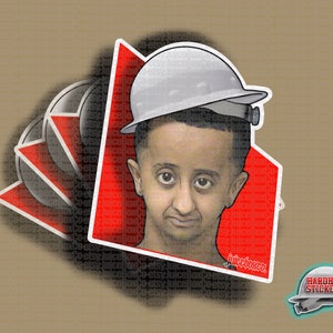 May include: A sticker featuring a cartoon illustration of a person wearing a white hard hat. The sticker has a red background with the text "juiceboxco" in white. The sticker is on a brown surface.