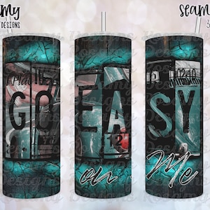 May include: A teal and black tumbler with a distressed look. The tumbler has a graphic of a vintage car with the words "Go Easy on Me" printed on it.
