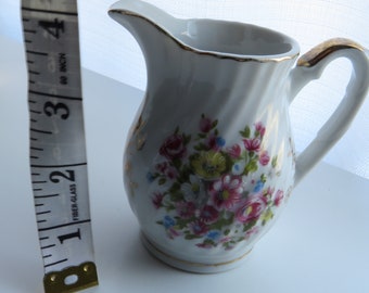 Beautiful ceramic creamer with floral design!