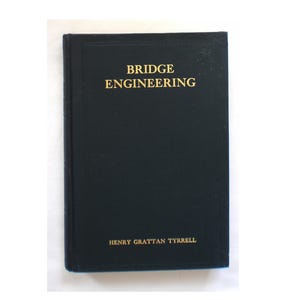 May include: A hardcover book titled "BRIDGE ENGINEERING" in gold lettering on a black cover. The author's name, HENRY GRATTAN TYRRELL, is printed at the bottom. The book is a classic reference for engineering.