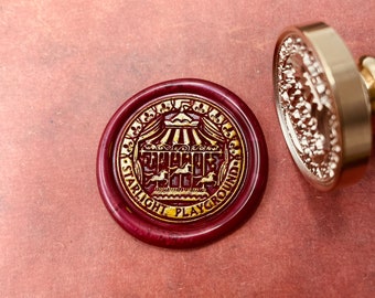 May include: A red wax seal with gold lettering that reads "Starlight Playground" and a gold illustration of a carousel.