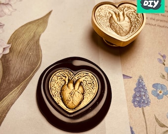 May include: A heart-shaped wax seal stamp and a wax seal with a heart design. The stamp is gold-colored with a detailed anatomical heart design. The wax seal is black with a gold heart design. The DIY logo is in the top right corner.