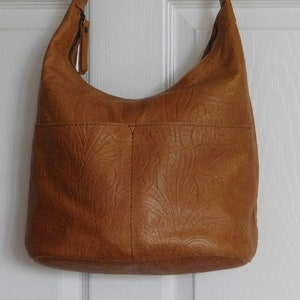 American Leather Co Hobo NWT tooled embossed Carrie Hobo with zippered top handbag purse Won at a charity event Price on their site is 175