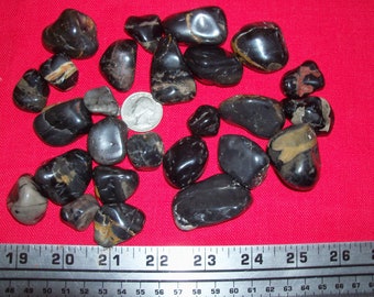 Black jasper polished tumbled gemstones. 1/4 pound lb per lot. About 6 or 7 gemstones per lot.