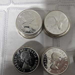 May include: A collection of silver Canadian coins featuring the profile of Queen Elizabeth II and a moose on the other side. The coins are in good condition and have a shiny finish.